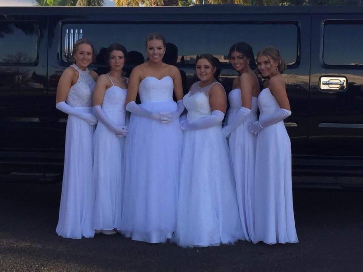 Debutantes beside the limousine